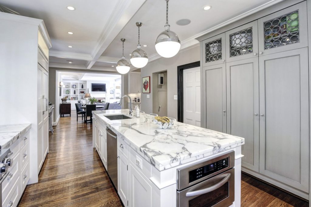 the-kitchen-is-bright-and-updated-with-marble-countertops-and-luxury-appliances